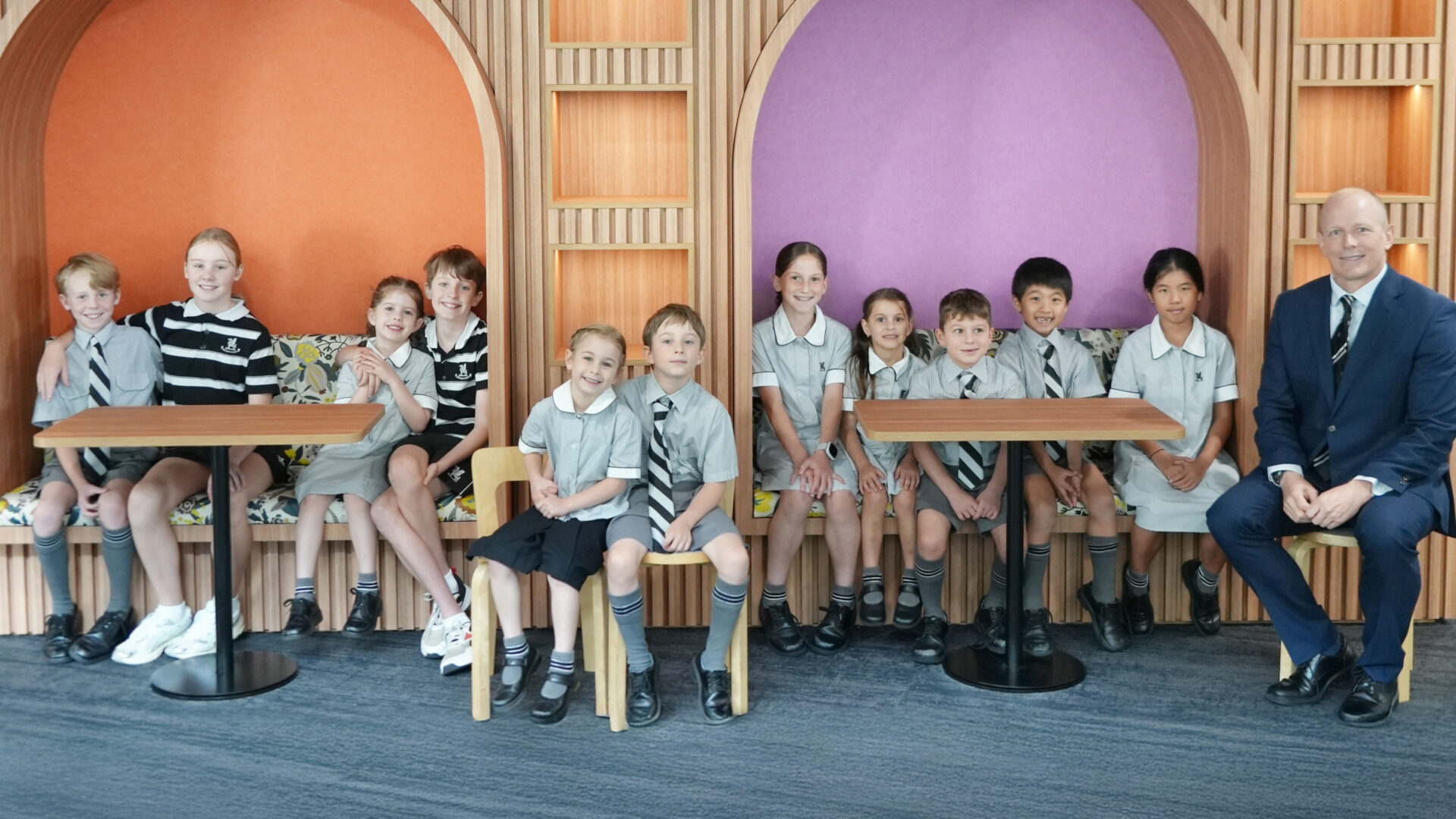 wyvern-bbh-169 Students seated at tables in a colourful school learning space.